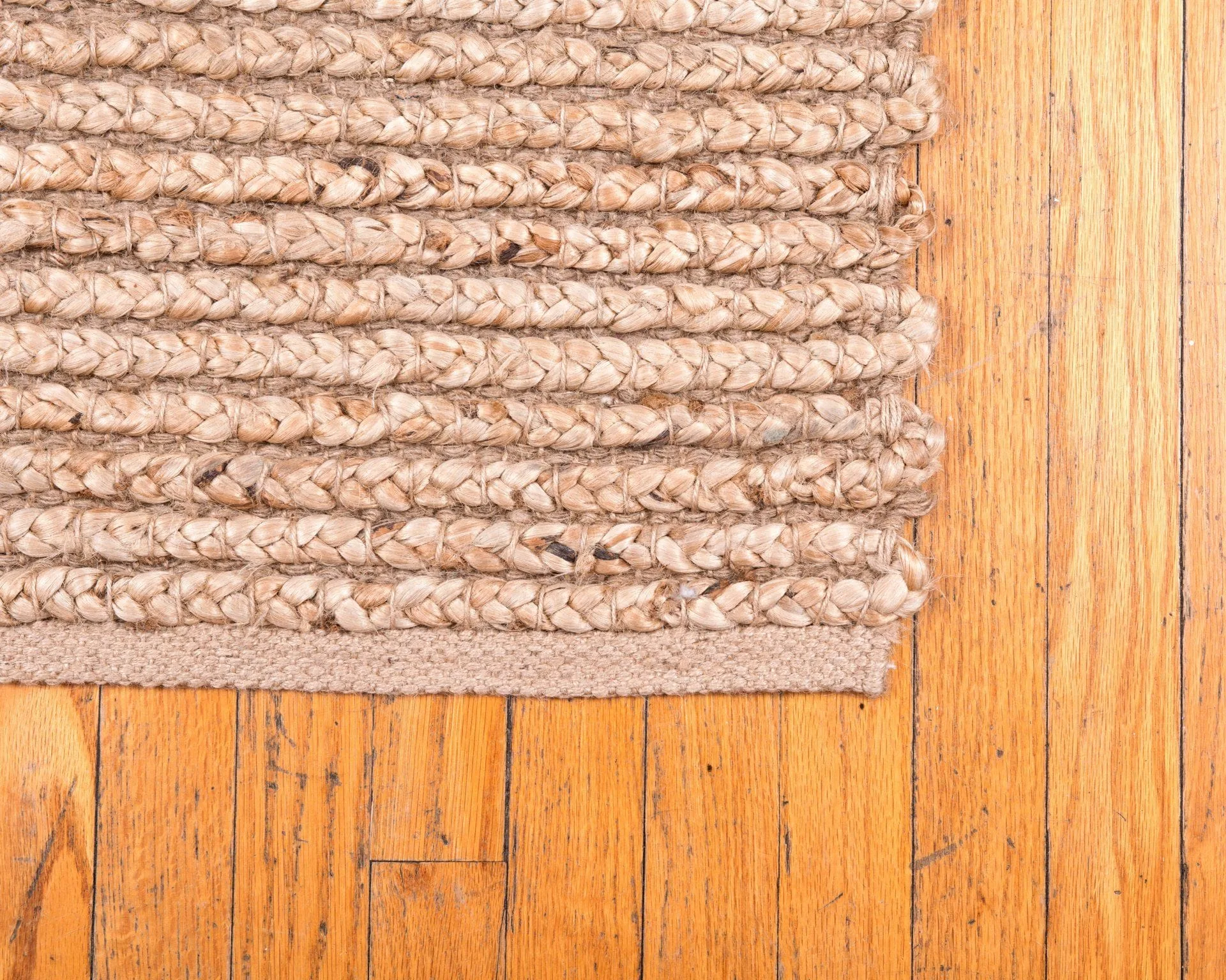 How to Care for Your Area Rugs 30 a braided jute rug on a hardwood floor