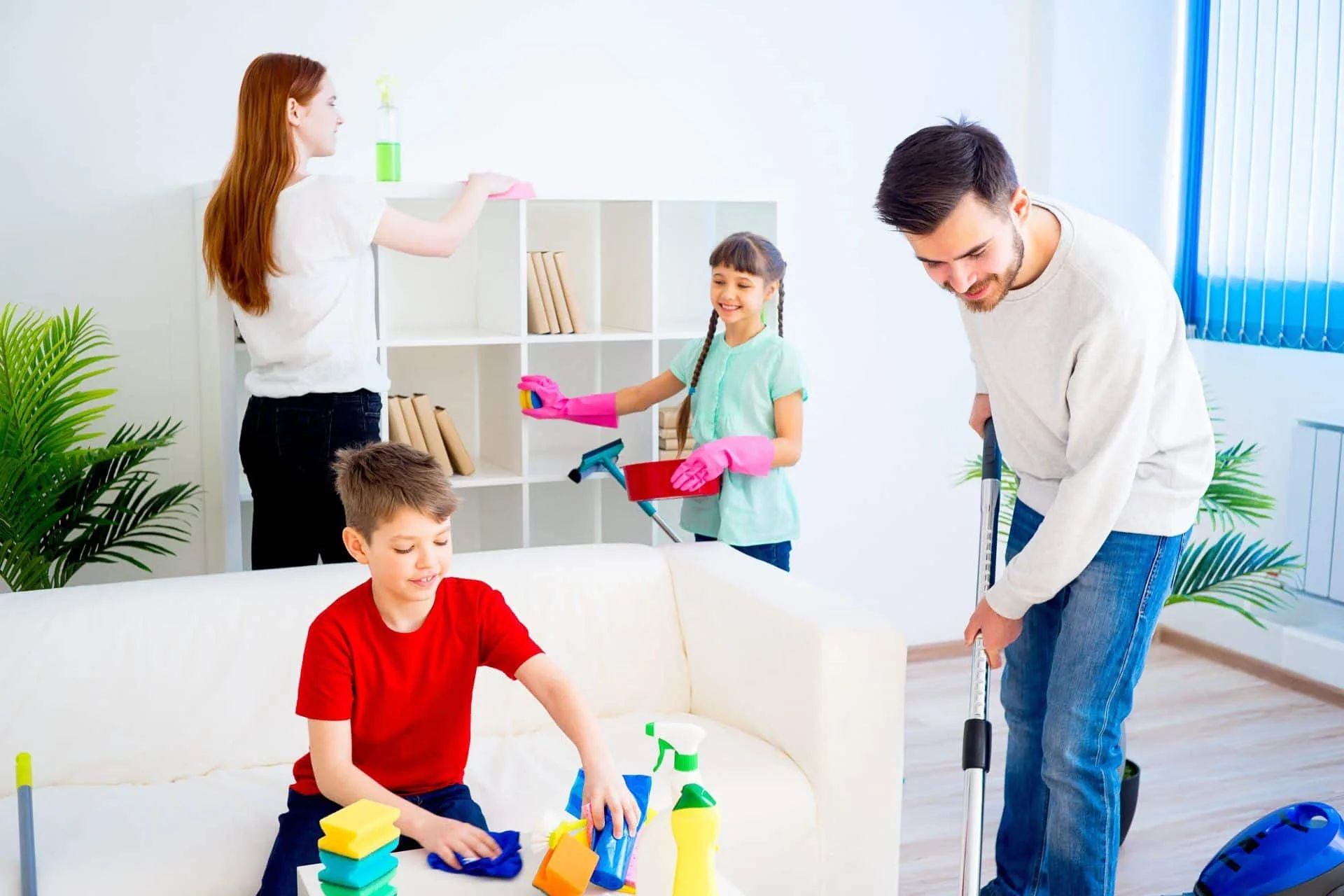 7 Cleaning Resolutions to Start Your New Year Off Right 3 family of 4 cleaning a living room together