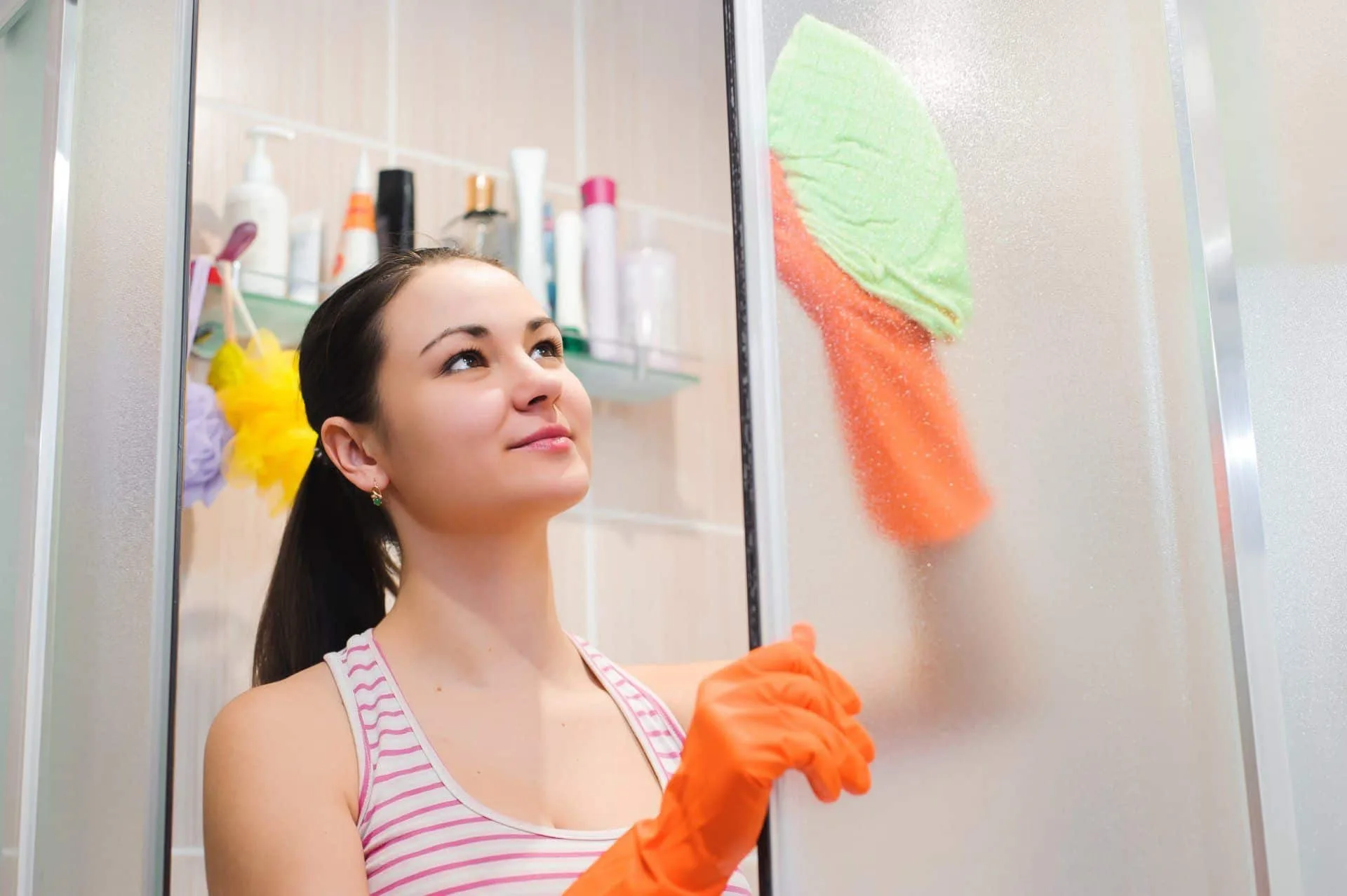 9 Things You Can Clean While Working Remotely 33 woman cleaning a shower