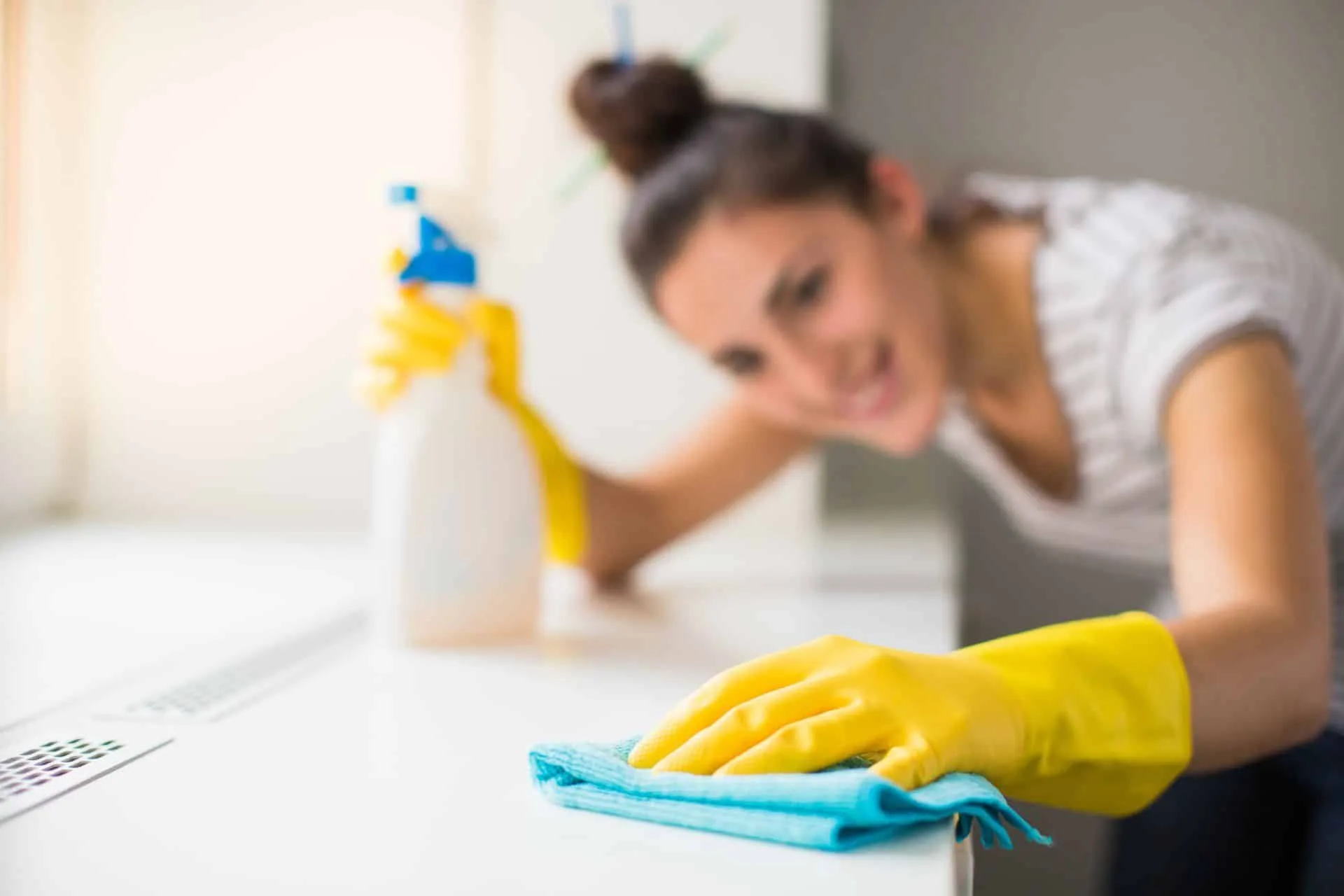 How to Clean Your House Using Bleach 2 woman cleaning with bleach in yellow gloves