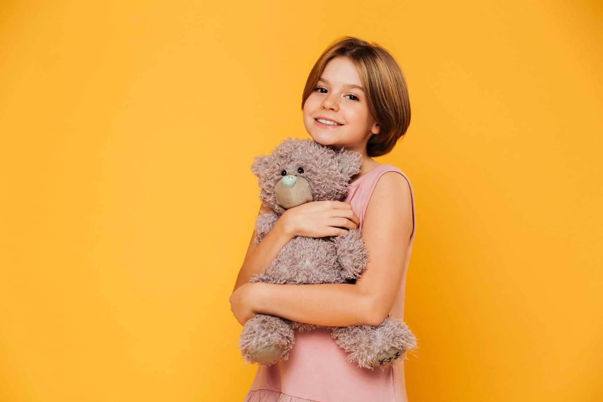 Time To Purge: Ways to Declutter and Reorganize 5 girl hugging a teddy bear