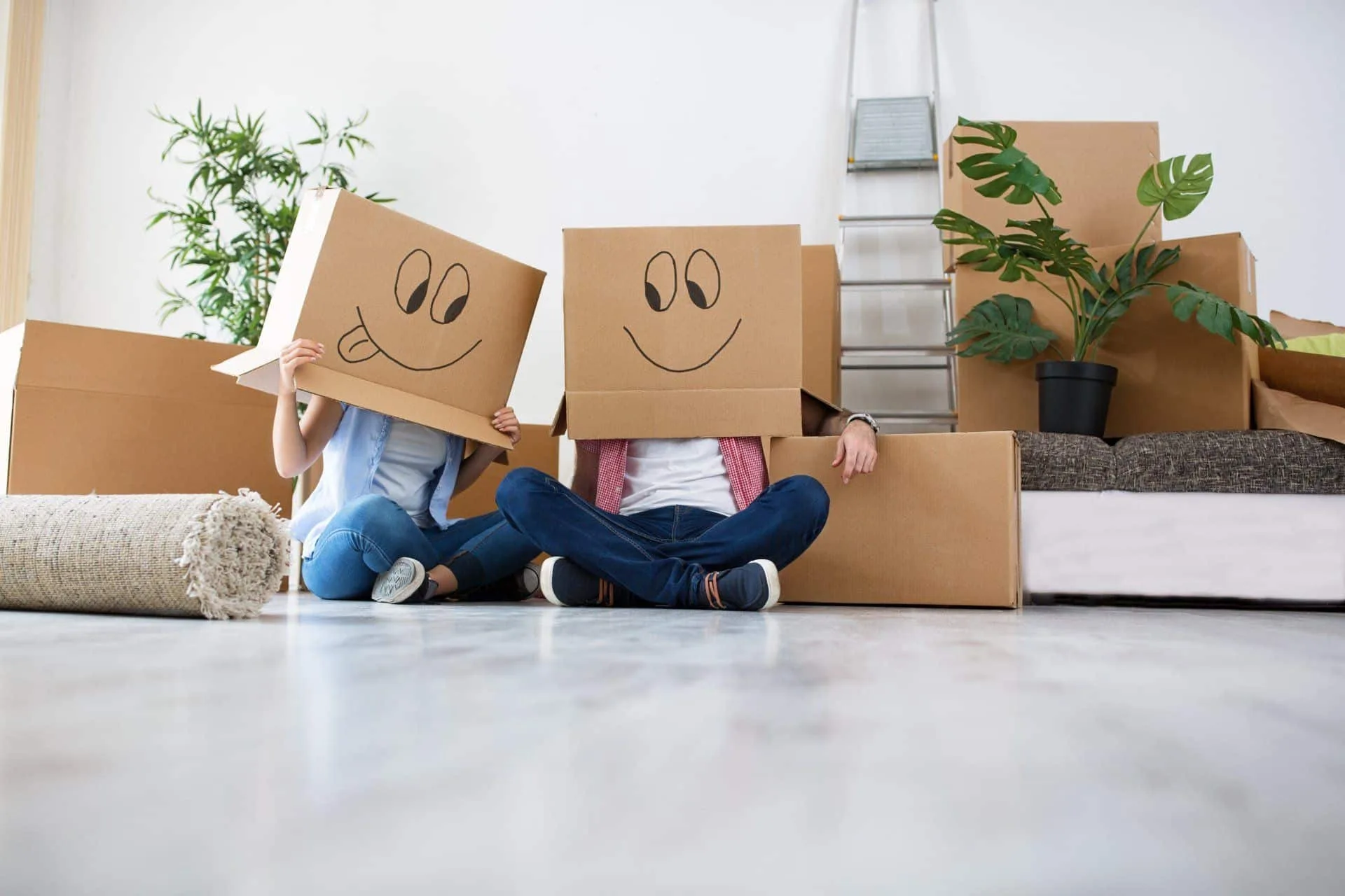 Your Move Out Cleaning Checklist 2 couple moving with cardboard boxes with happy faces drawn on them on their heads