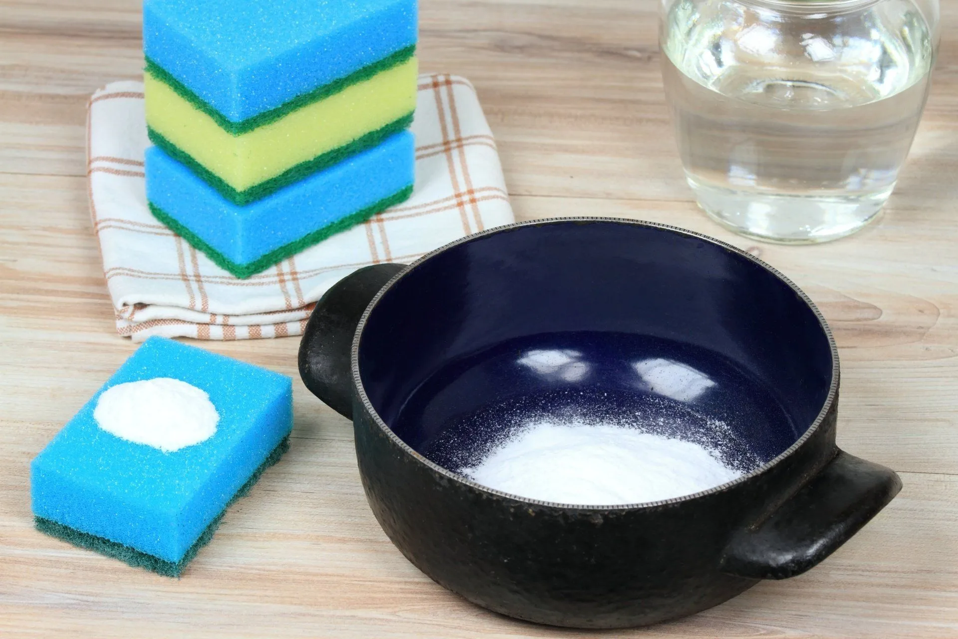 How to Easily Clean Your Home Using Baking Soda 9 baking soda in a pot and a sponge