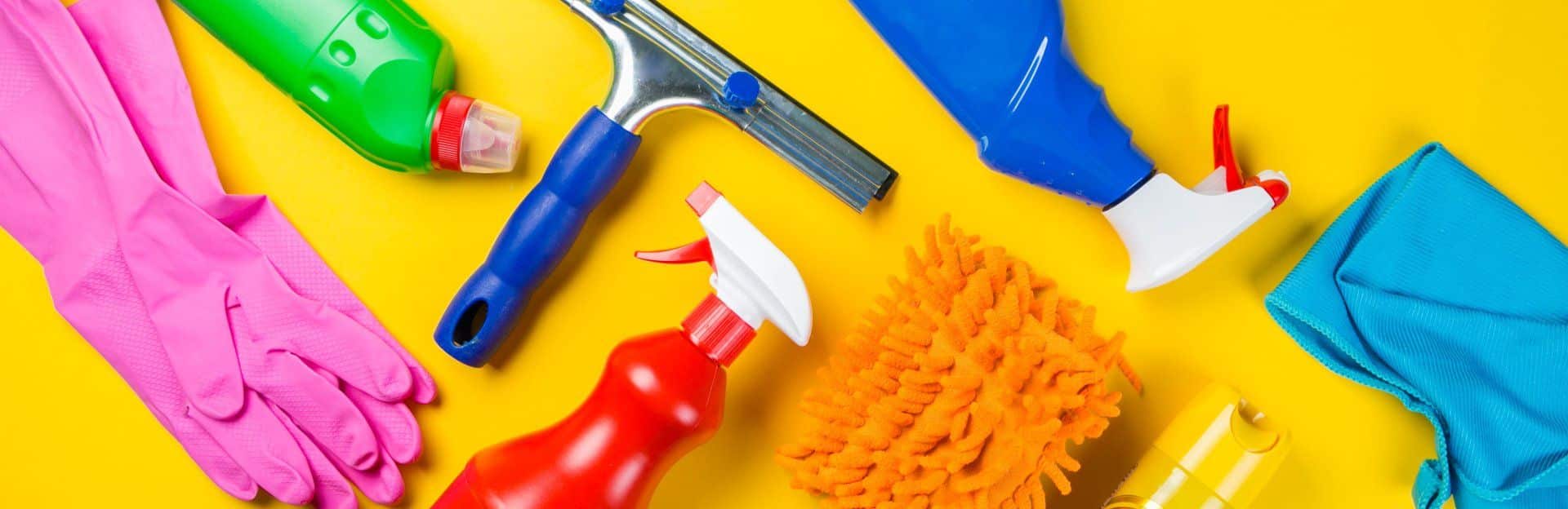 Various cleaning supplies on a yellow background