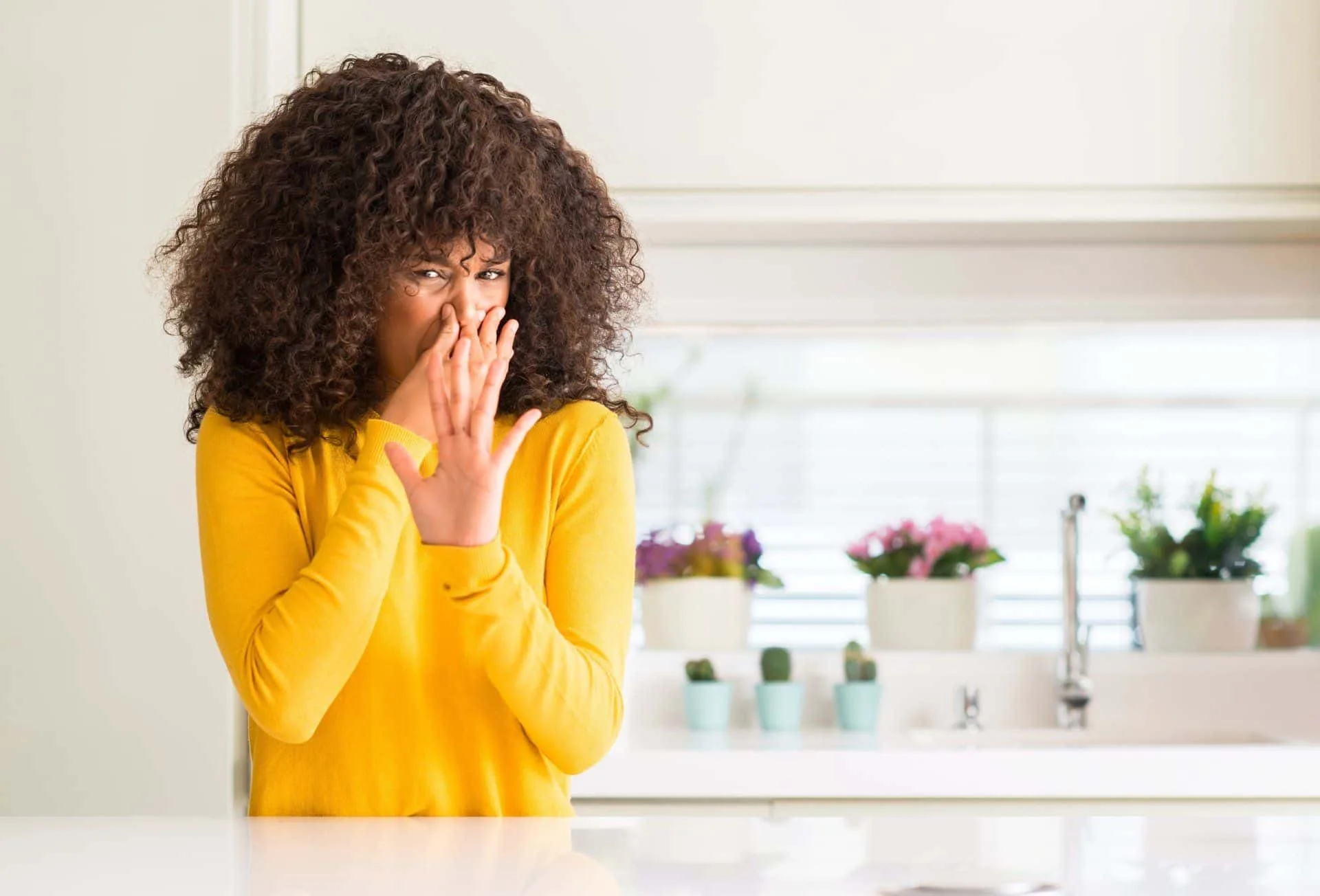 How to Have the Best Smelling House on the Block 42 woman in yellow shirt plugging nose