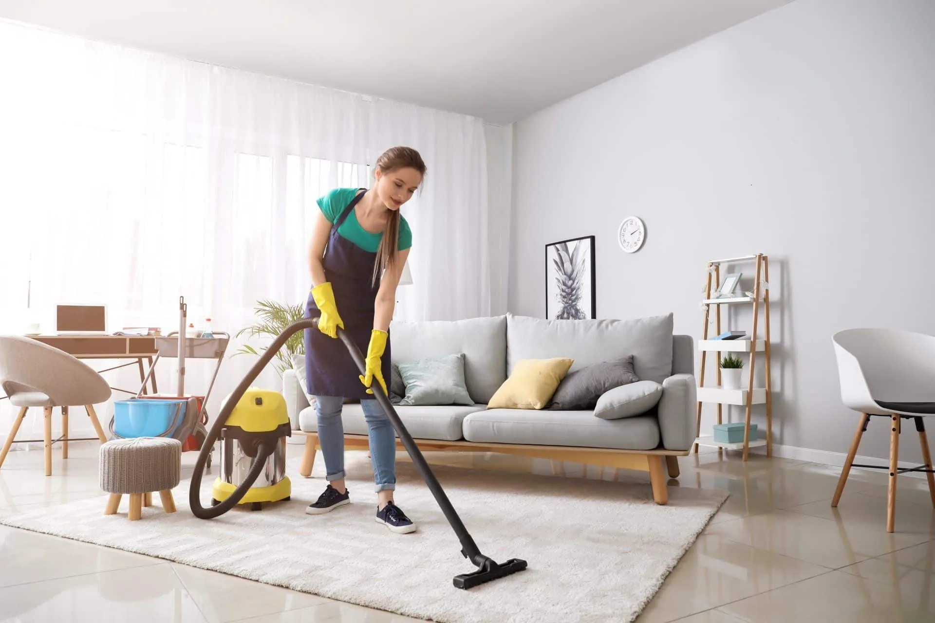 How to Care for Your Area Rugs 26 someone doing area rug cleaning with a vacuum