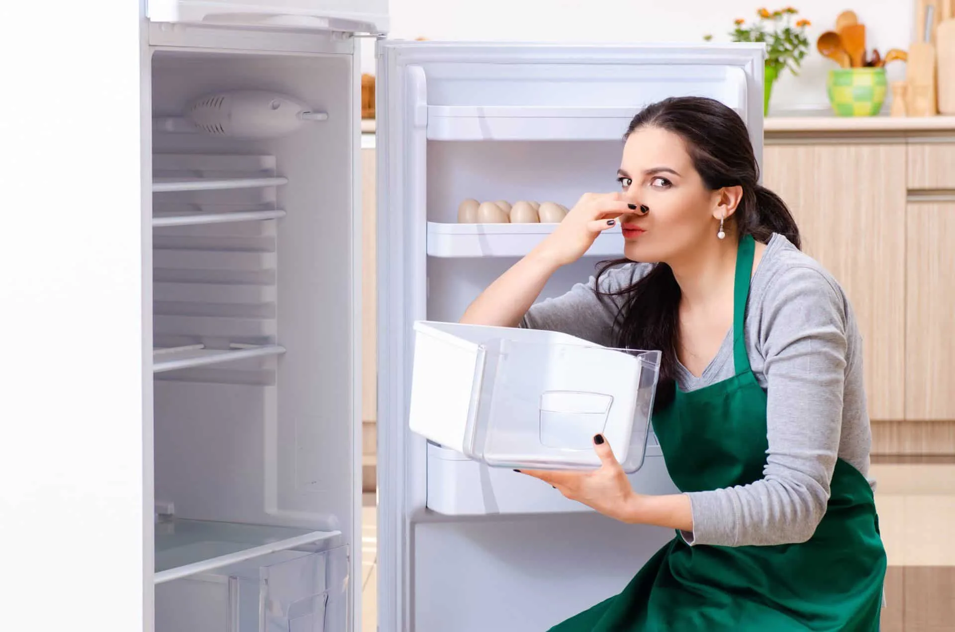 How to Have the Best Smelling House on the Block 46 woman holding up fridge drawer plugging nose