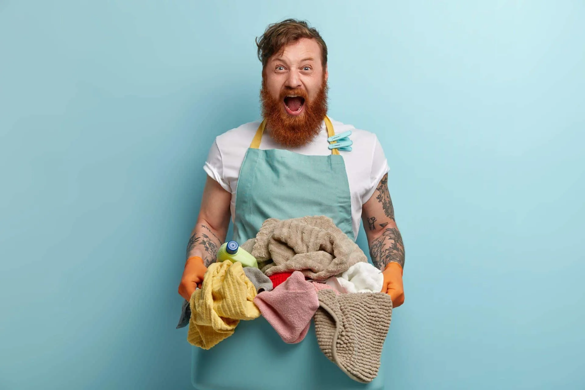 How to Have the Best Smelling House on the Block 47 man with a look of surprise on his face holding up laundry