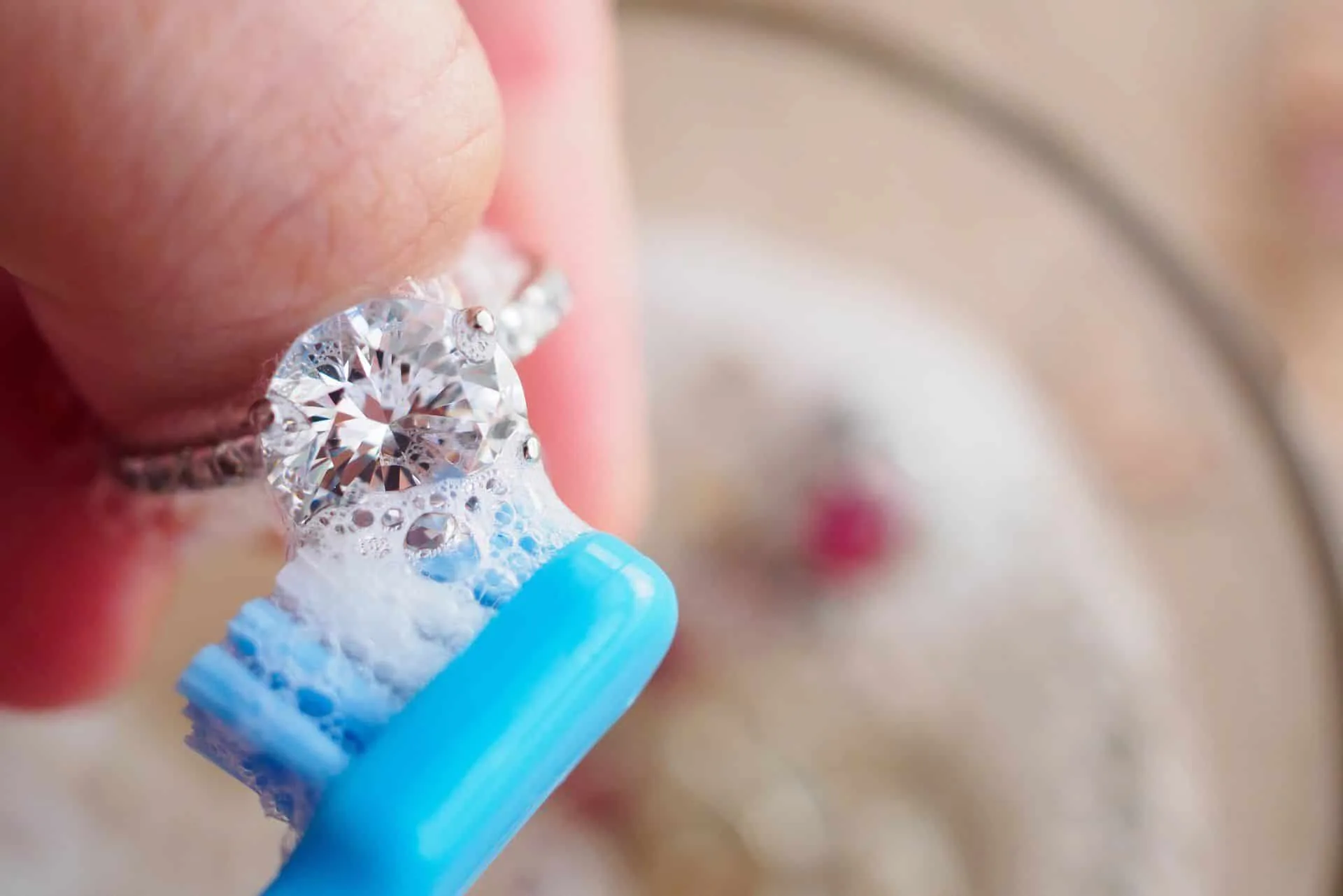 How to Easily Clean Your Home Using Baking Soda 11 someone cleaning an engagement ring with a toothbrush and baking soda
