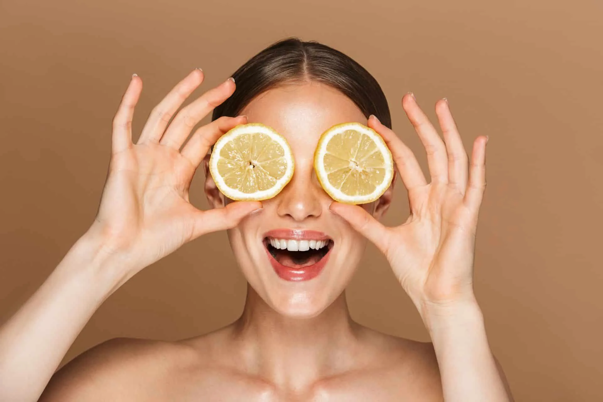 Get Your Cleanest Bathroom Ever 16 woman holding round lemon slices to her eyes