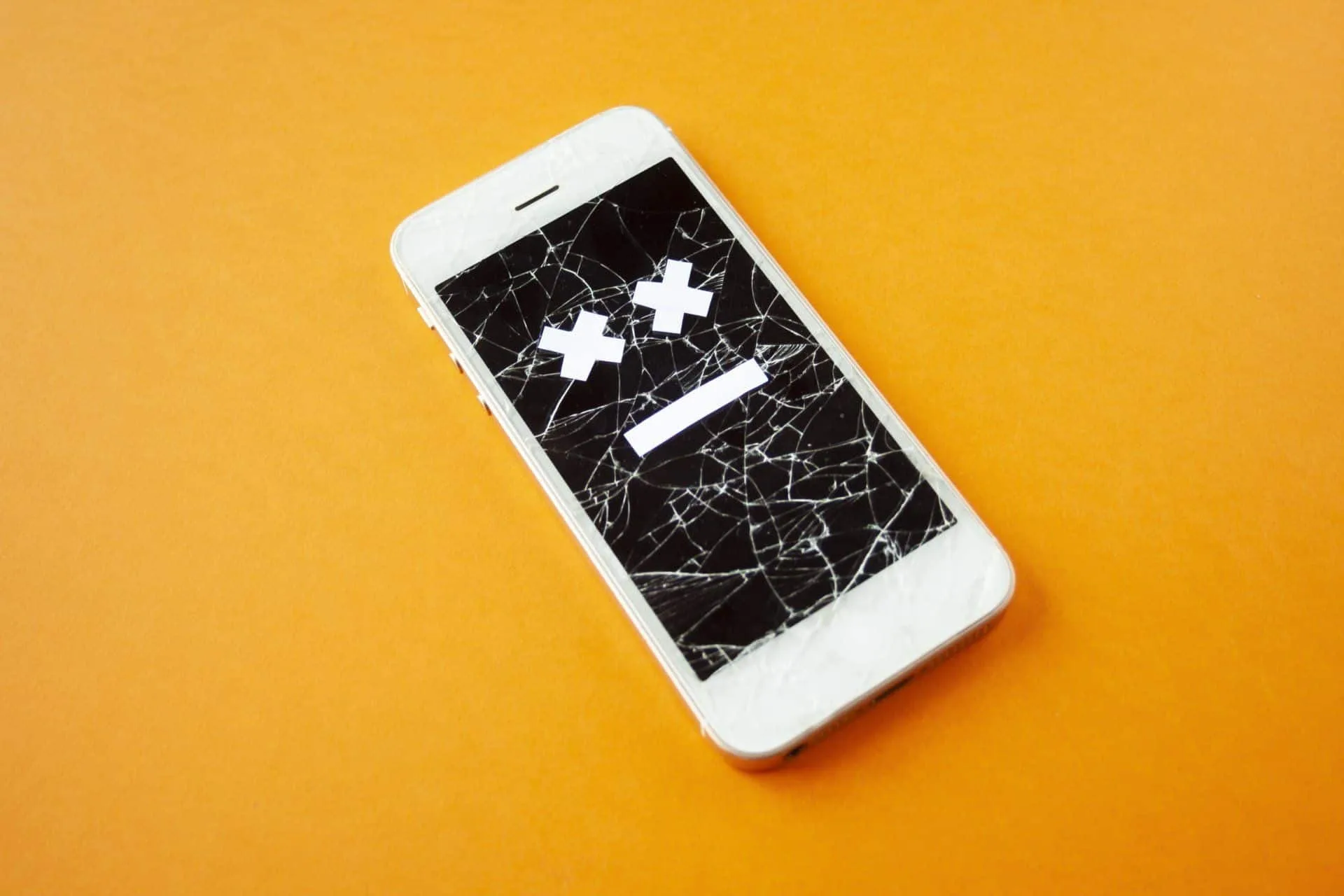 Time To Purge: Ways to Declutter and Reorganize 4 an iPhone with a cracked screen and a face with