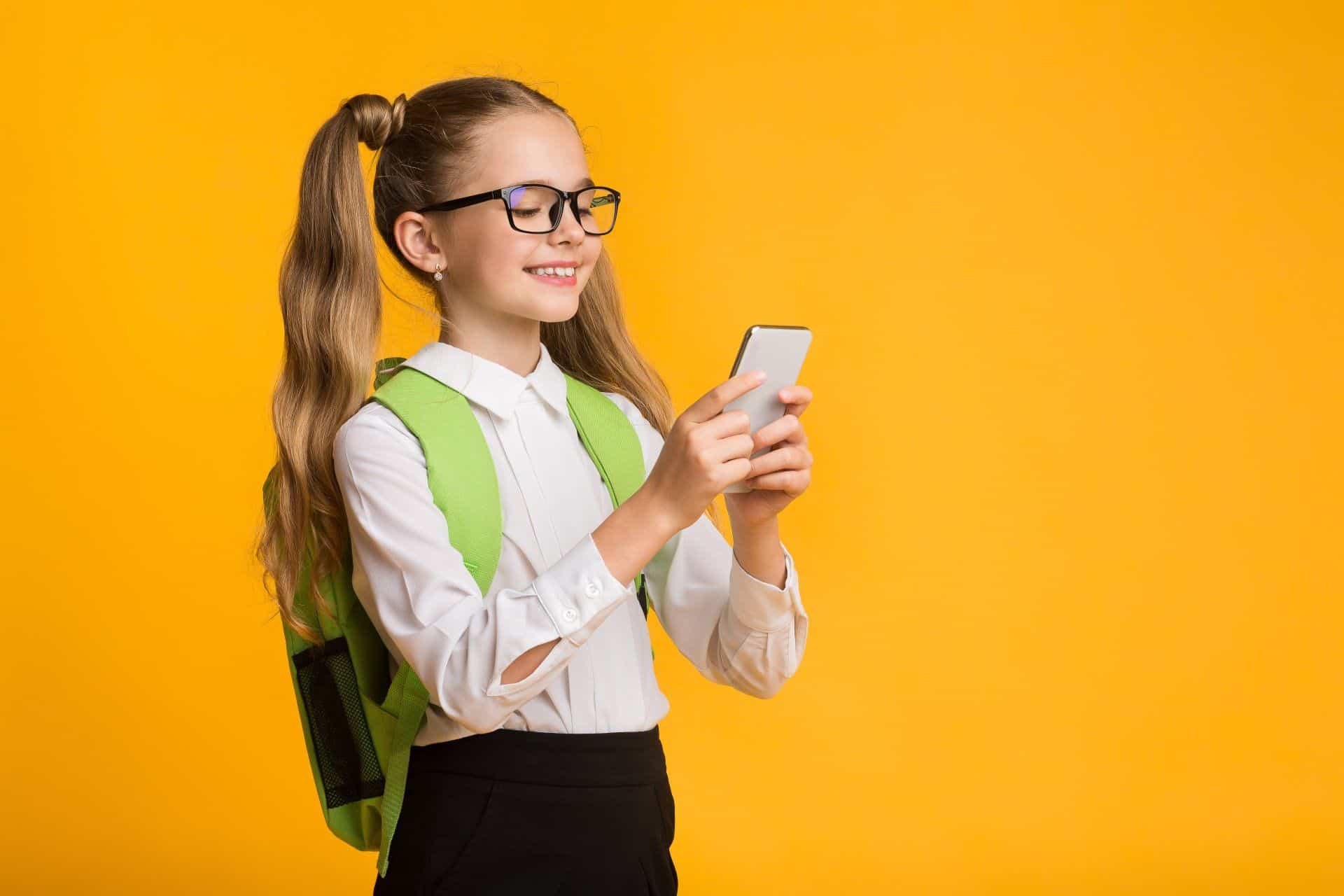 a girl in pigtails using a smart phone