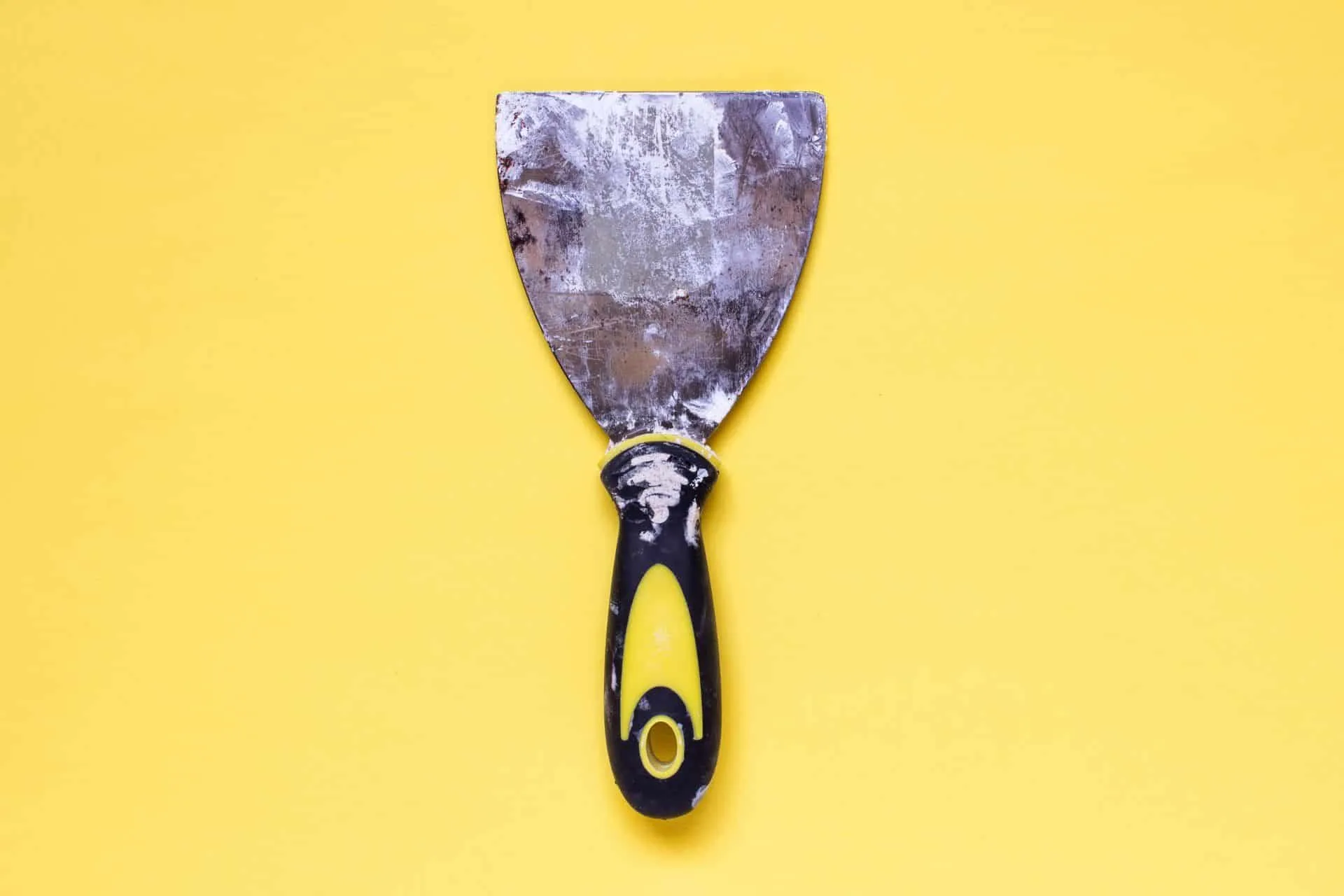 Your Move Out Cleaning Checklist 4 a tool for spackle on a yellow background