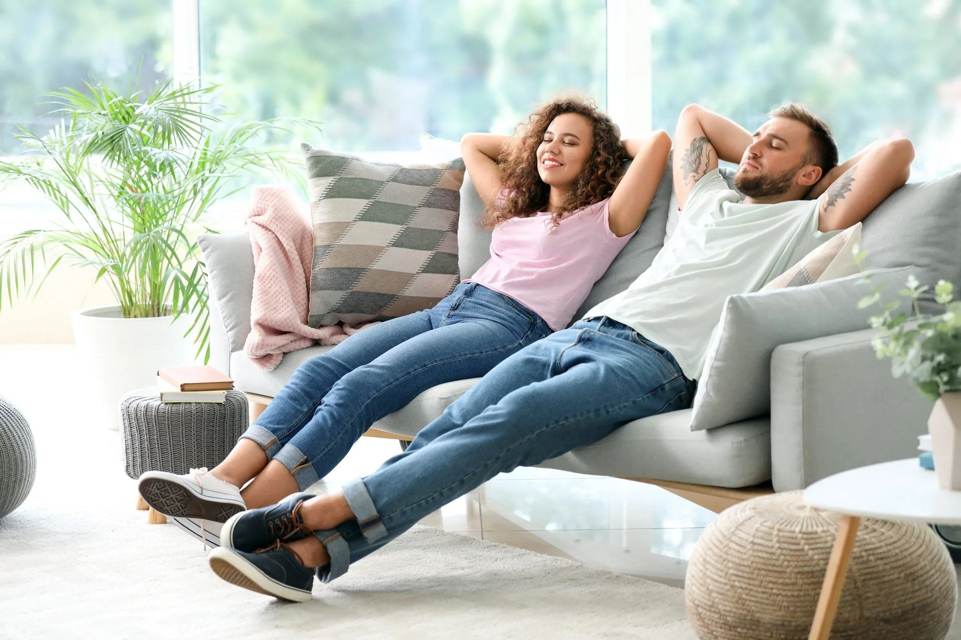 What's the Difference Between Cleaning, Disinfecting and Sanitizing? 14 a couple laying back and relaxing on their couch in their clean home