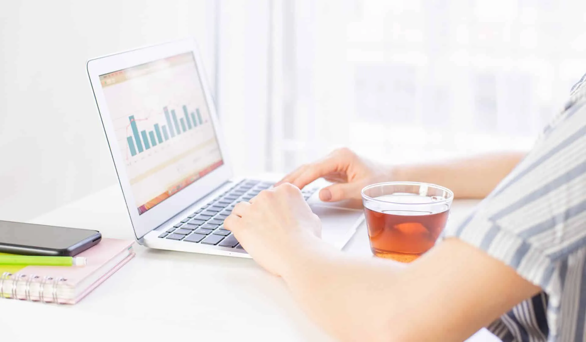 9 Things You Can Clean While Working Remotely 28 a person having tea while working remotely on their computer