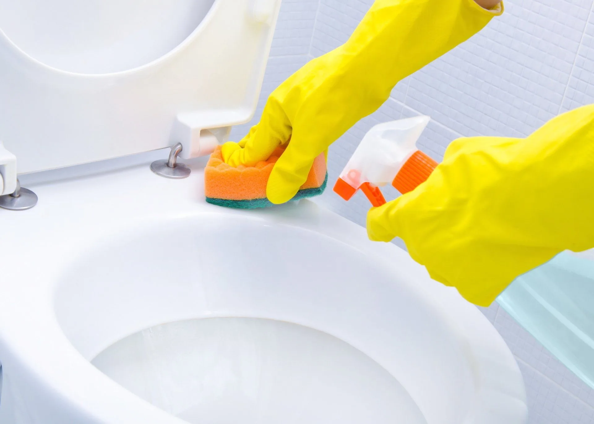 Get Your Cleanest Bathroom Ever 19 someone in yellow rubber gloves cleaning a toilet
