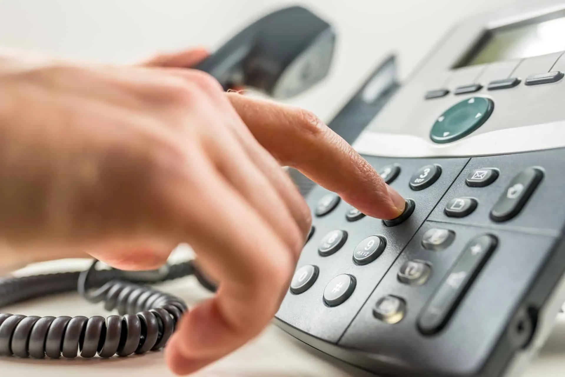 Why Your Office Needs a Commercial Cleaning Service 18 person dialing numbers on a office phone