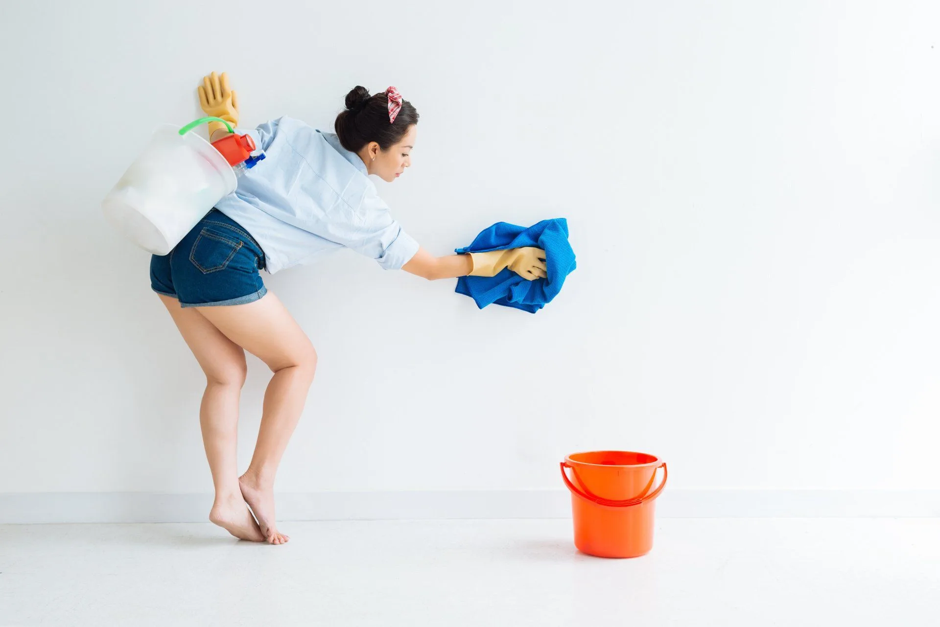 Get Your Cleanest Bathroom Ever 15 woman cleaning walls with a blue towel