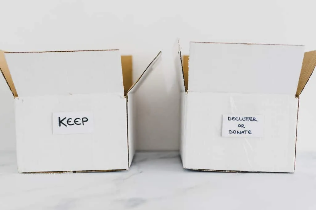 5 Hall Closet Organization Tips 6 A box that says keep and a box that says donate.
