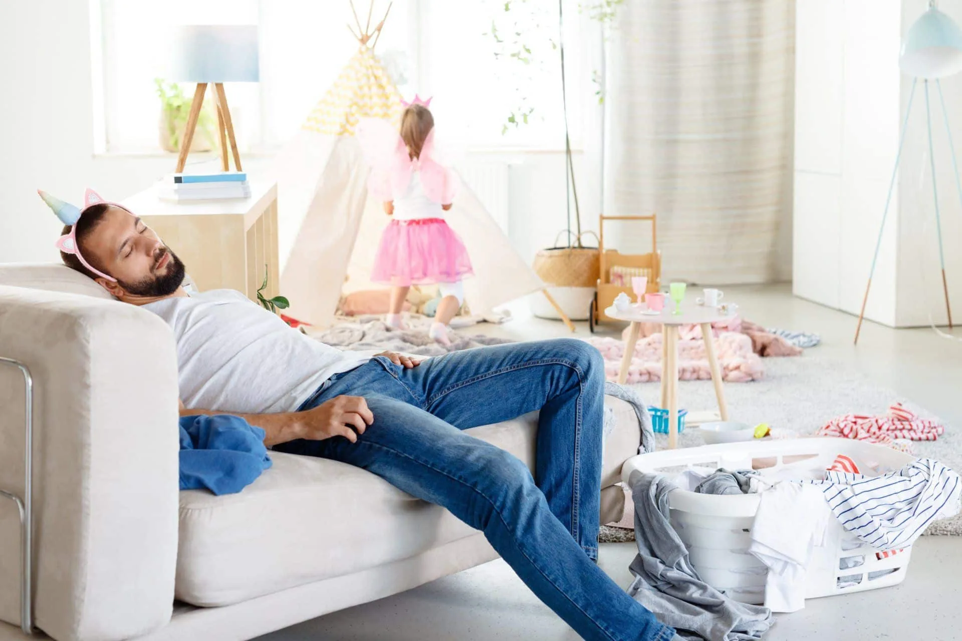 What You Should be Cleaning in Your Home Every Single Day 4 exhausted sleeping dad wearing unicorn costume in a messy house