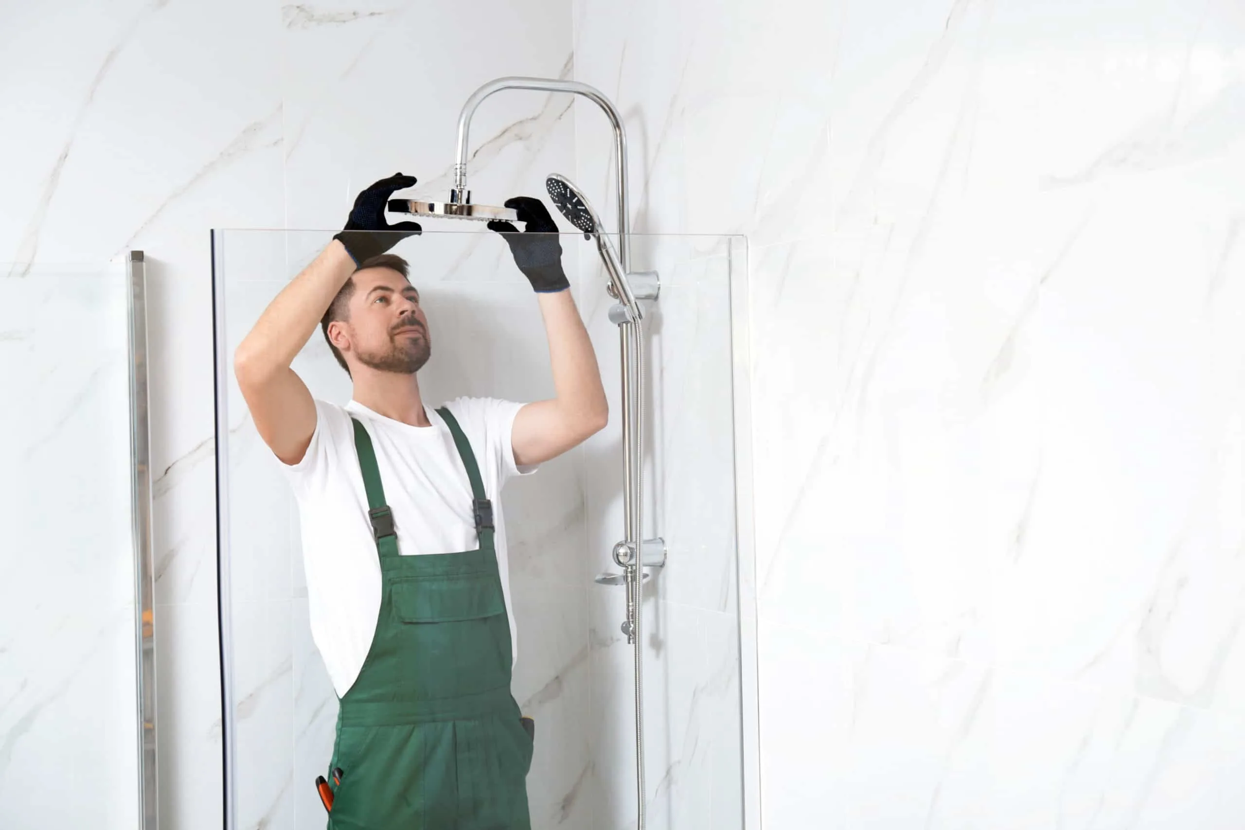 How to Clean a Shower Head 4 Professional handyman working in shower booth indoors