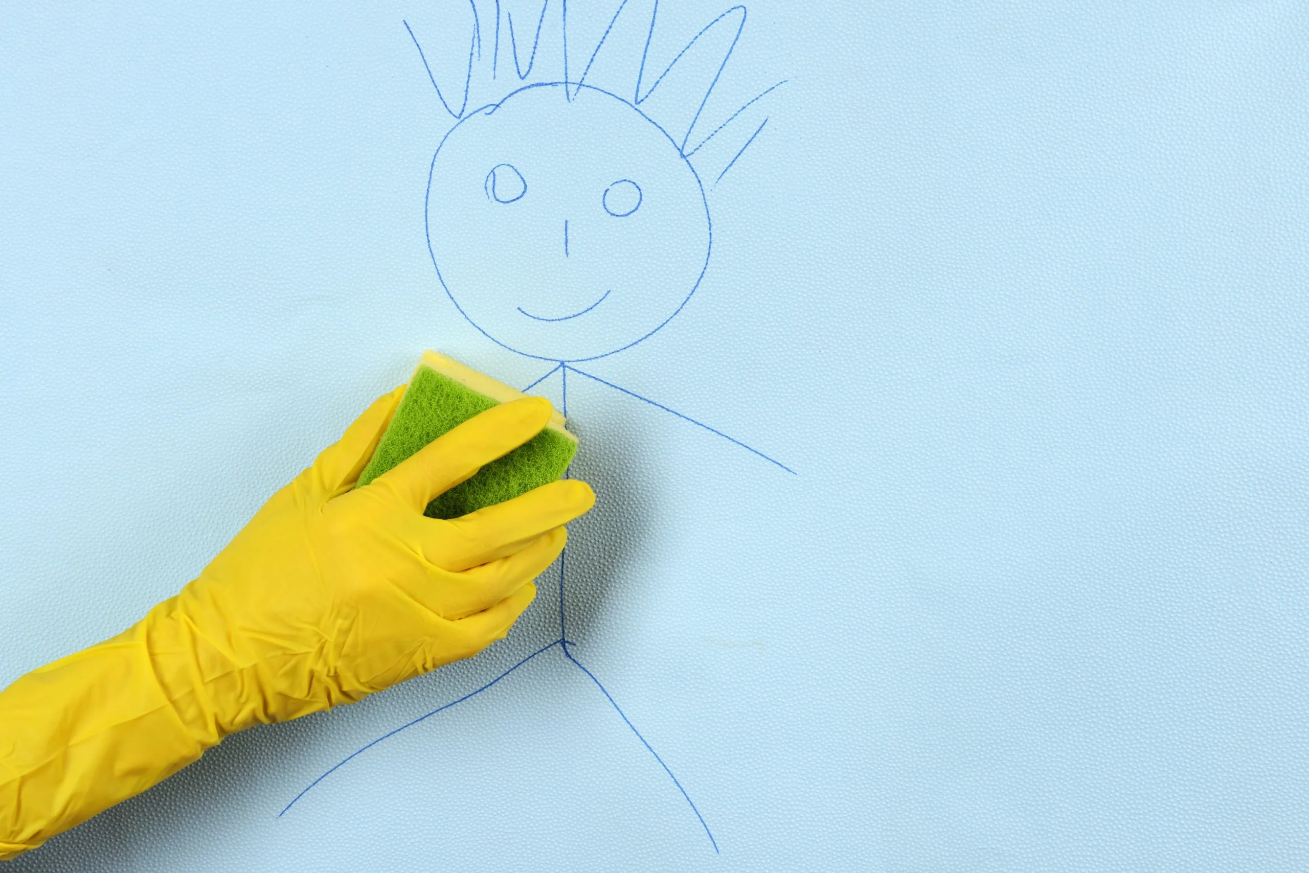 How to Get Crayon Off the Walls 2 Someone wearing a yellow rubber cleaning glove using a sponge on crayon on the walls.