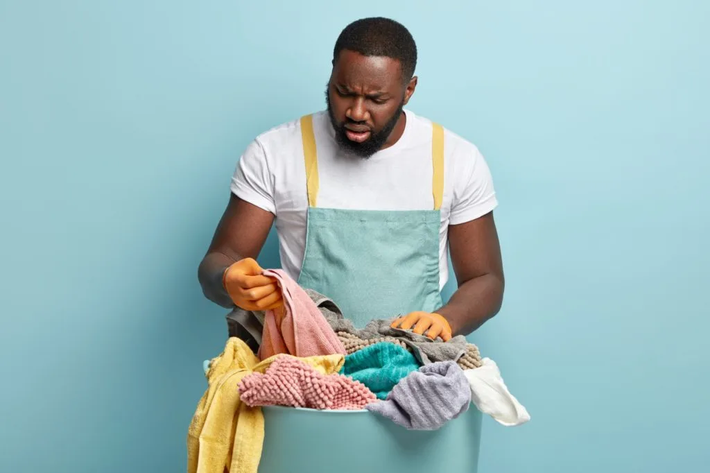 How to Get Nail Polish Out of Carpet 10 A man frustrated with stains in his dirty laundry