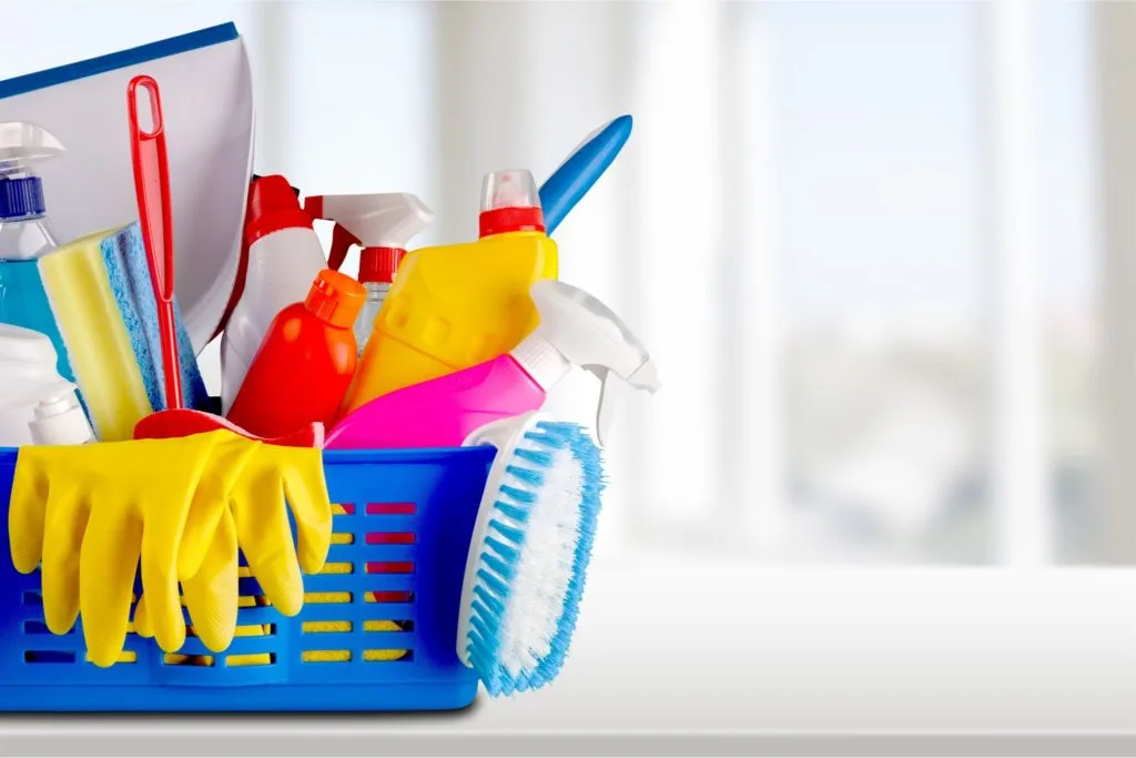 How to Clean Your House Cleaning Tools 10 A blue basket filled with house cleaning tools.