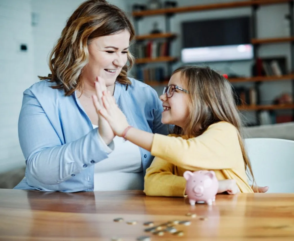 These 7 Chores for Kids Let You Delegate the Housework 8 A mom teaching her young daughter baout money and how to budget