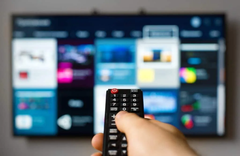 13 Things to Try and Make Cleaning Fun 7 Smoeone choosing a TV show to listen to while they clean.